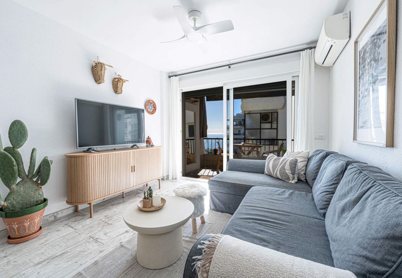 Blick auf den Aufenthaltsraum mit Fernseher und Terrasse in den Apartments Acapulco 302.